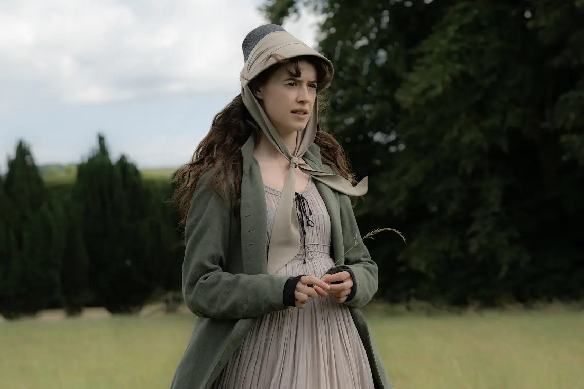 Daisy Edgar-Jones as Elinor Dashwood outdoors in a bonnet