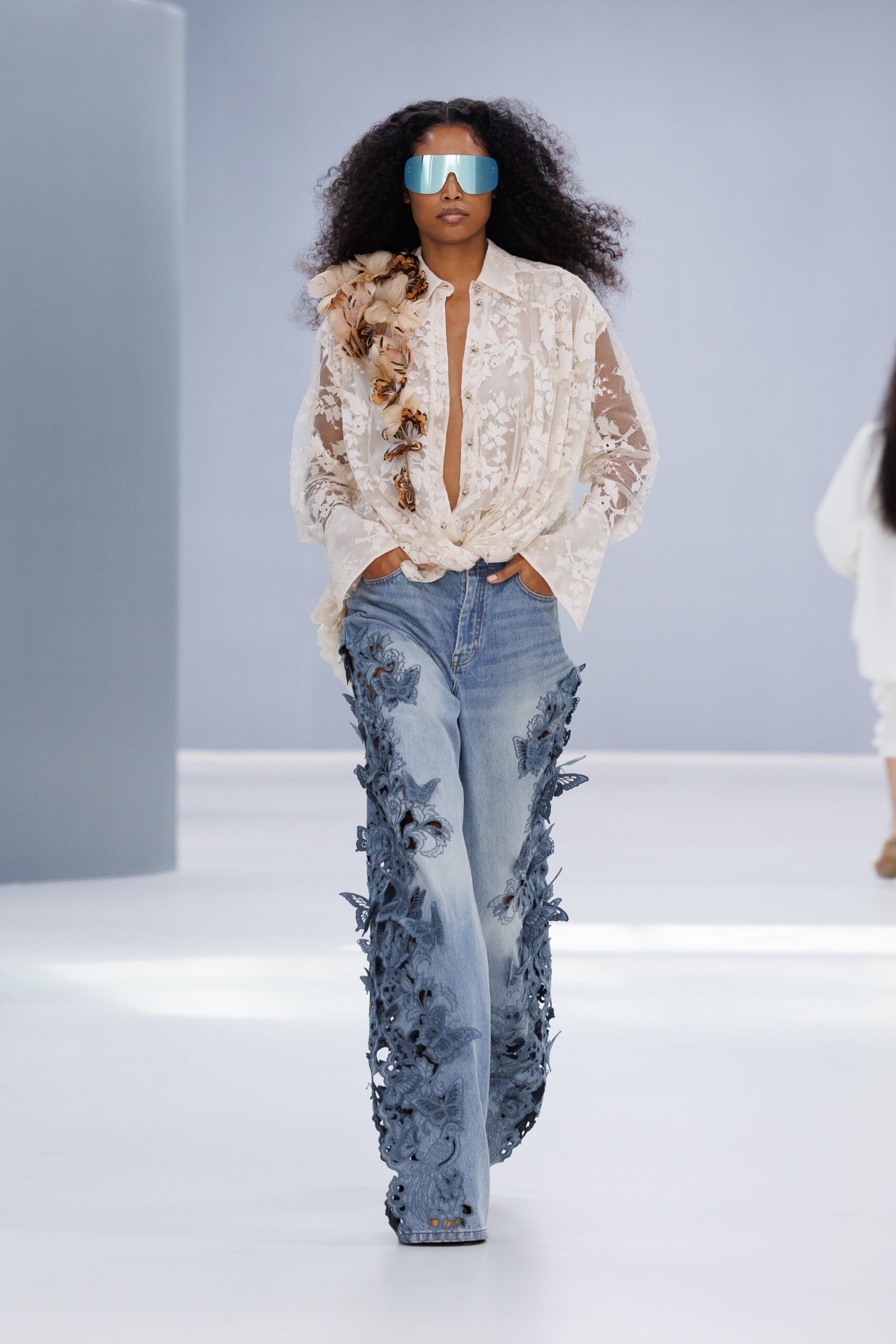 A white shirt paired with flared floral-appliqué denim on the Zimmermann runway