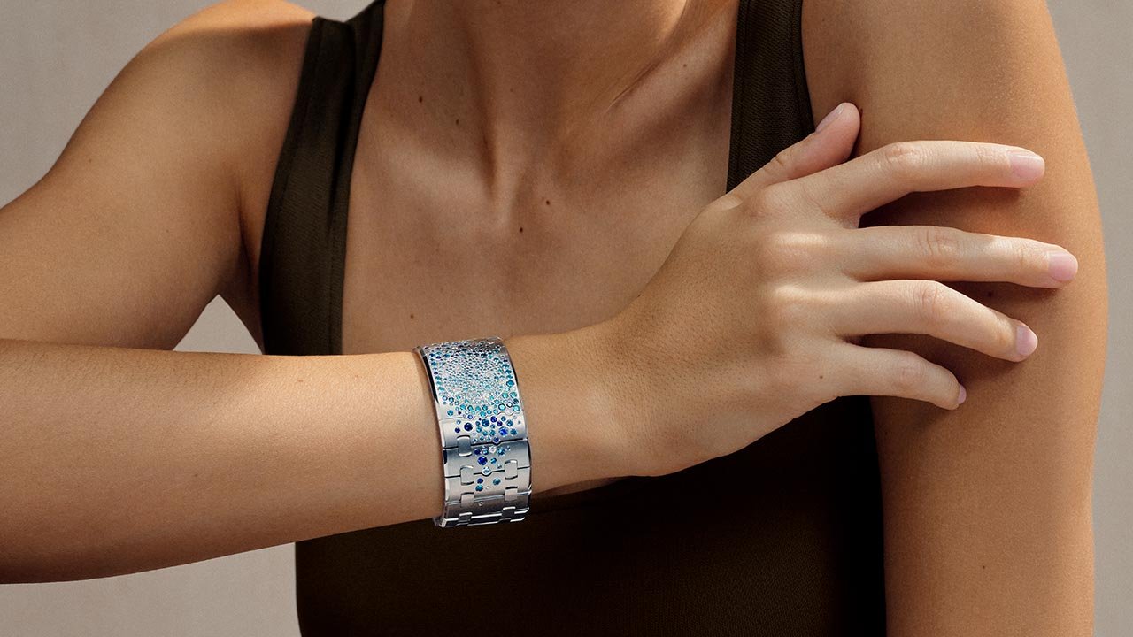A blue gem-set Royal Oak Joaillerie cuff is worn on a model's wrist