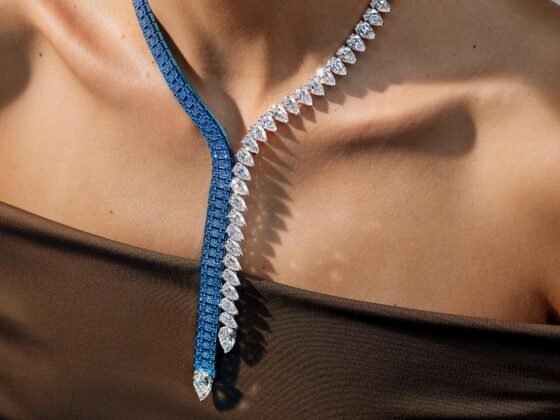 The Dream of Joux necklace combines blue gem-set links and pear-shaped diamonds against a dark top