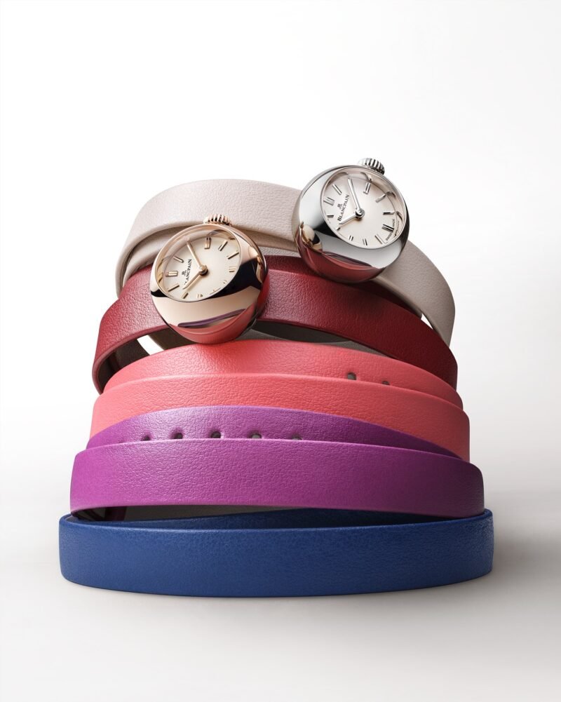 Two Blancpain Lady B watches arranged over colourful double-tour leather straps