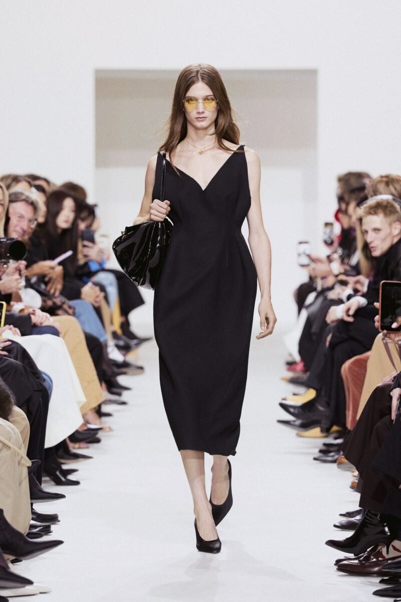 CELINE Été 2027: a black sleeveless dress with yellow-tinted eyewear