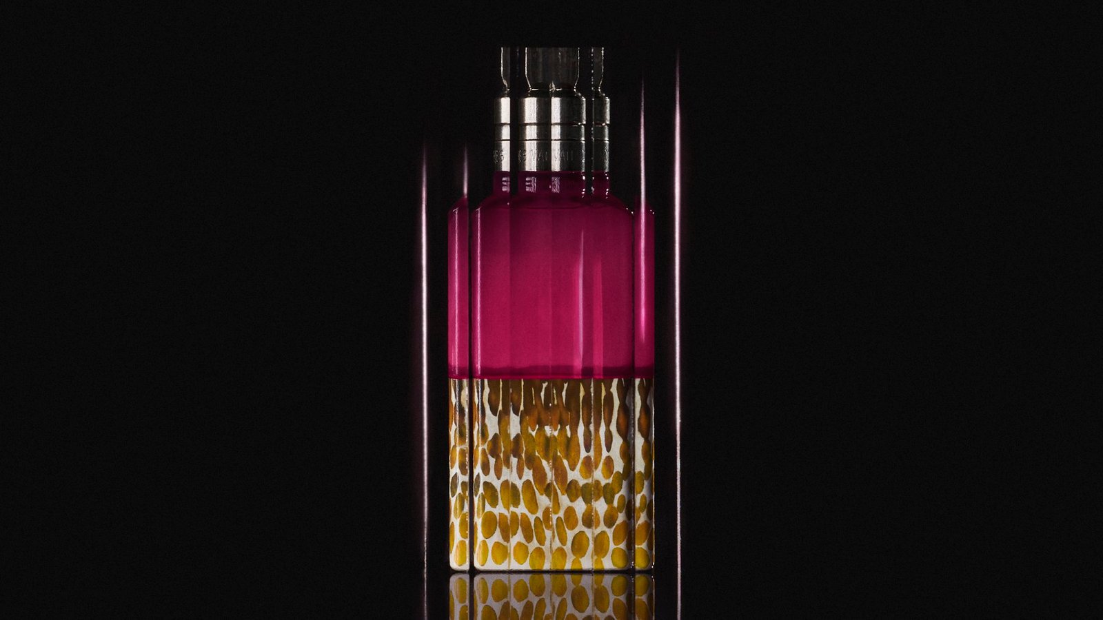 The purple Velvet Violet bottle and its seed-patterned base appear amid vertical optical streaks against black