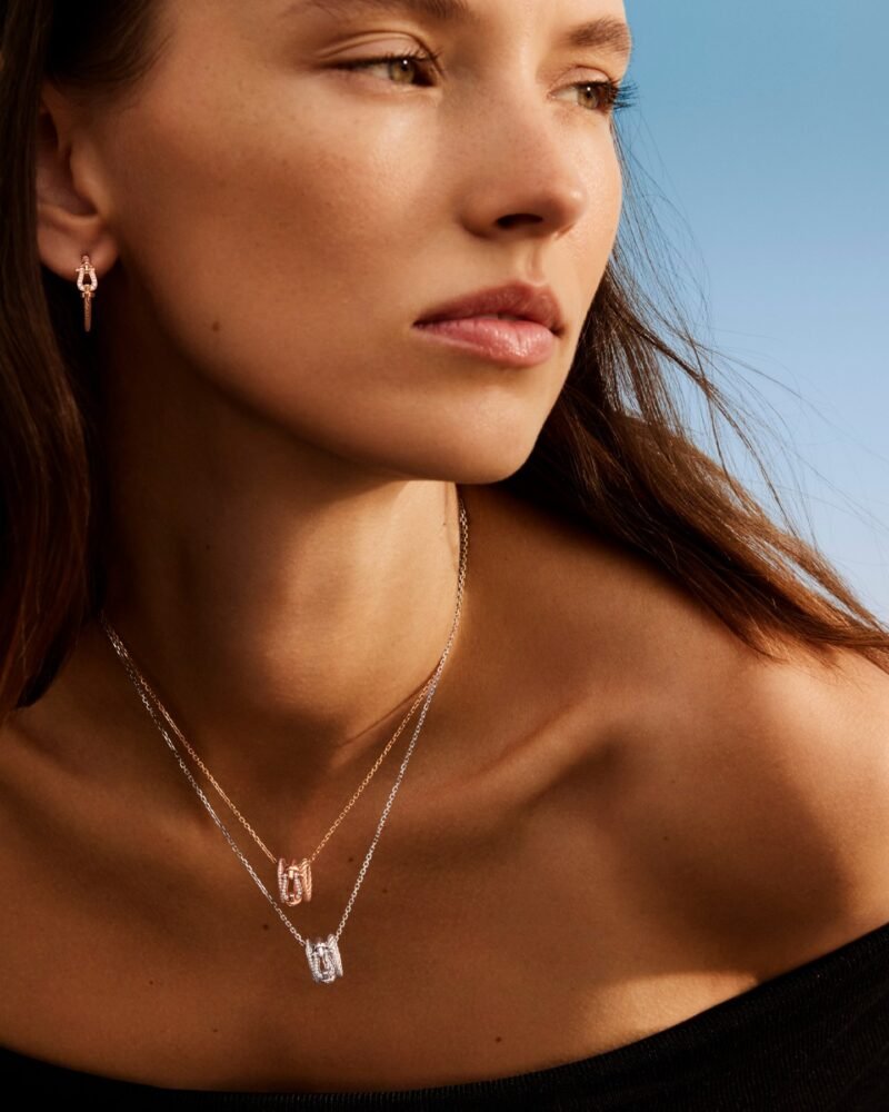 Model wearing layered FRED Force 10 necklaces and small drop earrings