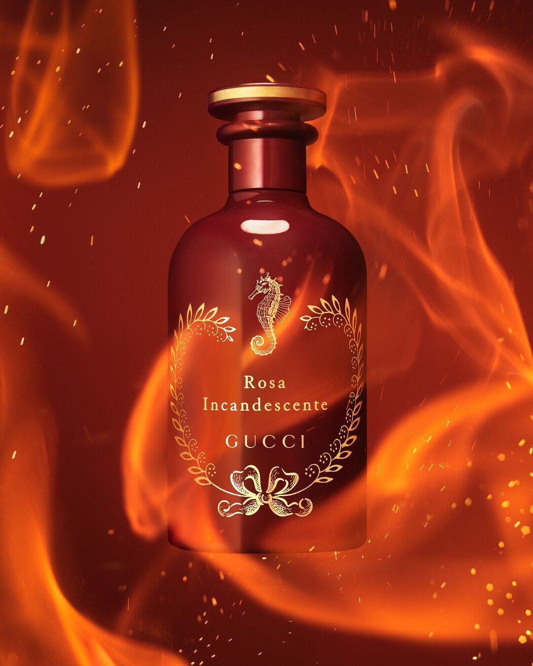 A red Rosa Incandescente bottle with a gold-coloured seahorse motif surrounded by glowing orange flame-like forms