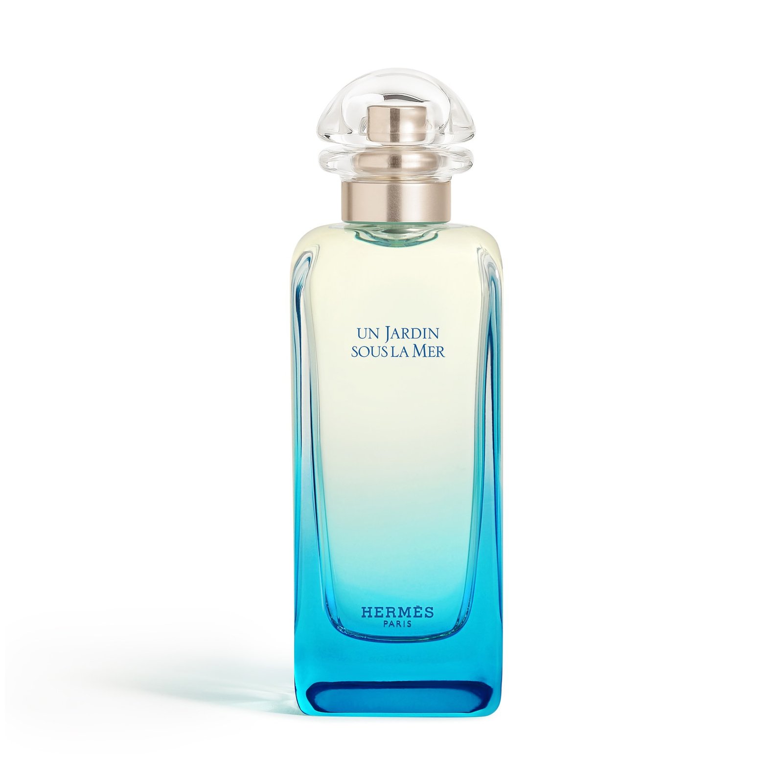 Hermès Un Jardin sous la Mer bottle with a rounded clear cap and glass graduating from deep blue at the base to pale green above