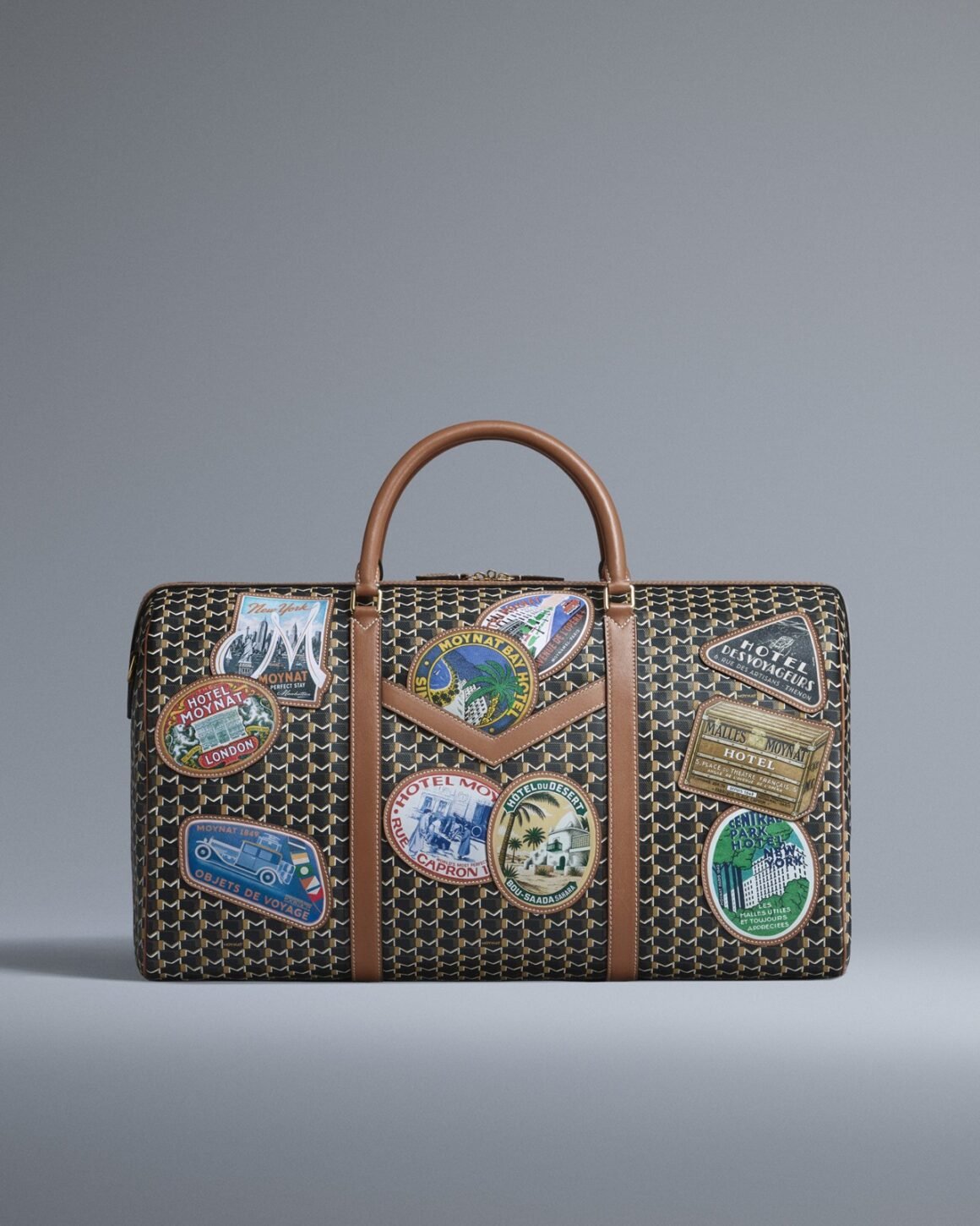 Hotel Moynat 48-hour duffle with tan leather handles and colourful travel patches