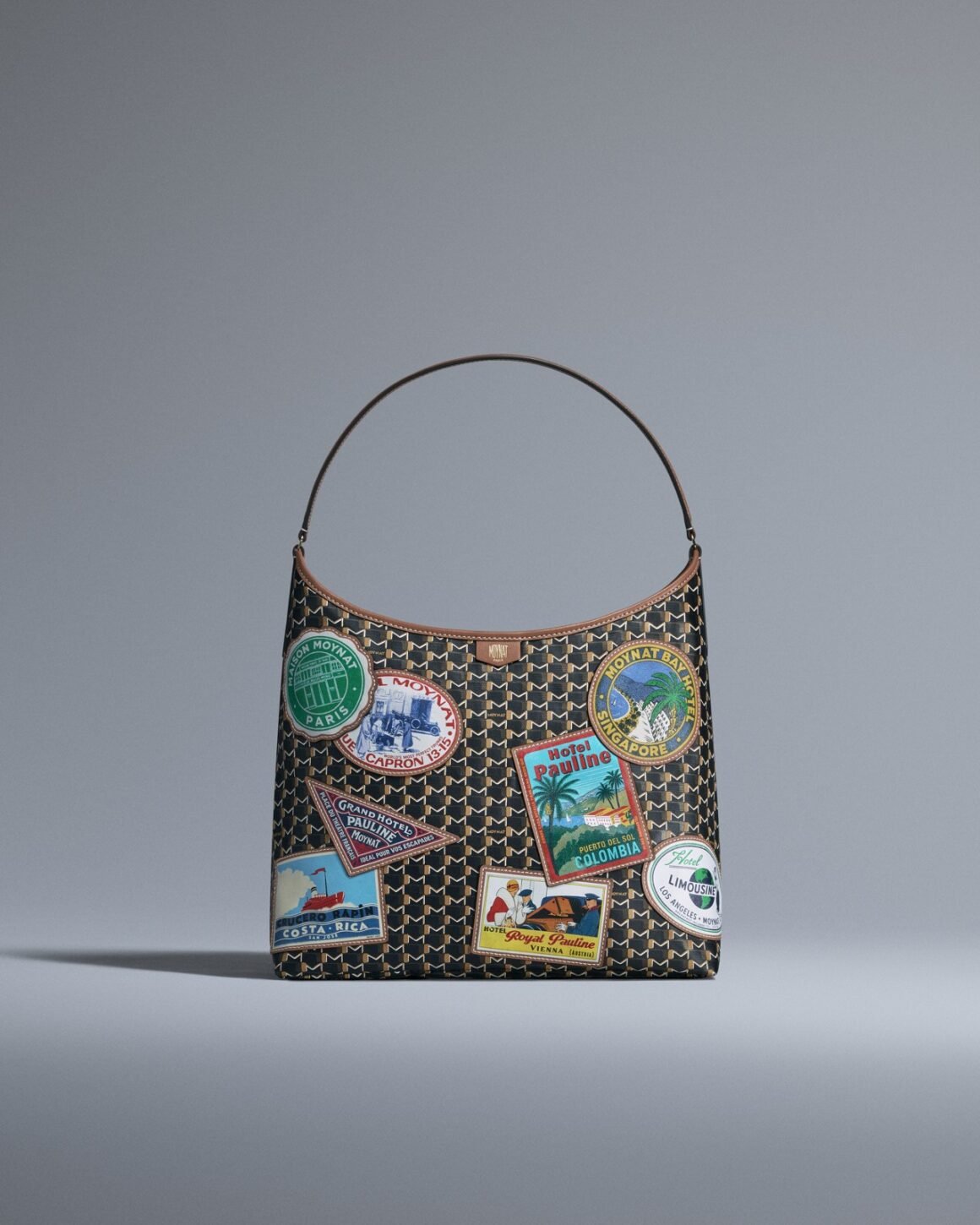 Hotel Moynat Hobo bag in Monogram M canvas with colourful stitched leather travel patches