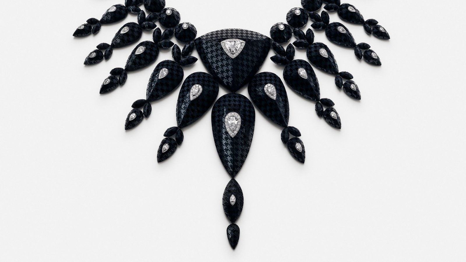 Checkers necklace, with a continuous houndstooth pattern engraved across its onyx stones.