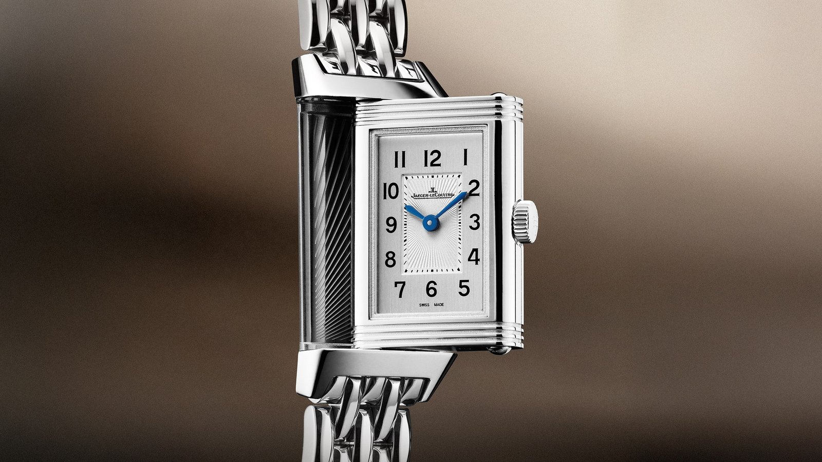 Reverso Origin steel bracelet model with Arabic numerals and its rectangular case partly turned