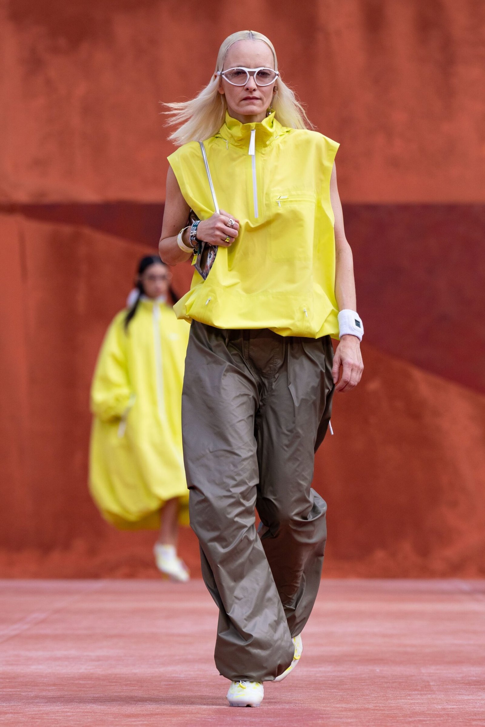 Yellow sleeveless top, dark trousers and yellow bag at Lacoste Spring/Summer 2027