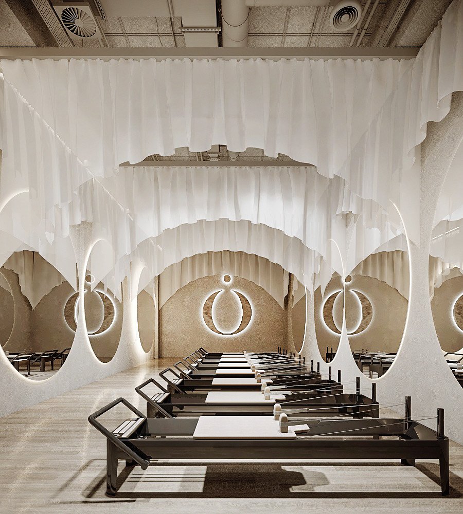 3D rendering of a studio with rows of exercise machines, tall oval mirrors and white fabric suspended in soft arches