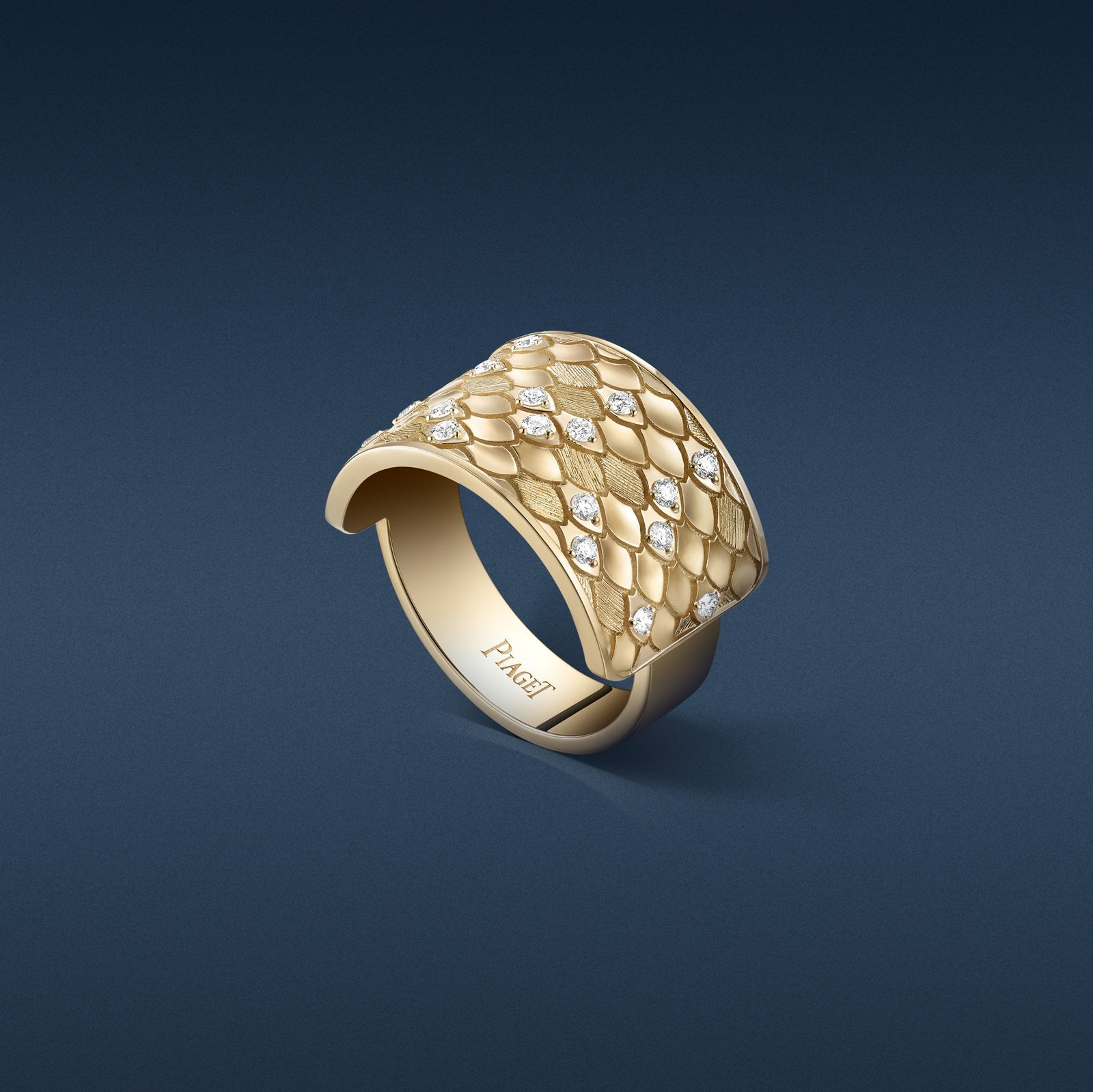 Piaget Glow yellow-gold ring with a scale-inspired texture and 17 diamonds totalling 0.24 carats.