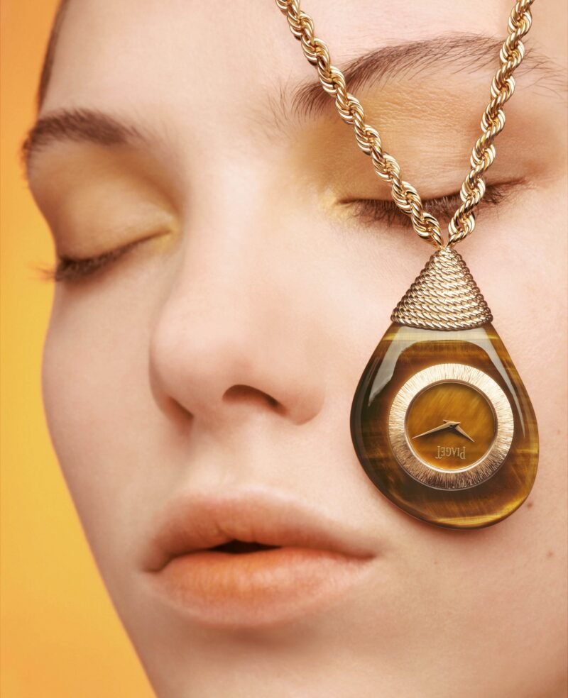 Piaget’s tiger’s-eye Swinging Pebbles pendant watch in yellow gold, photographed by Brigitte Niedermair.