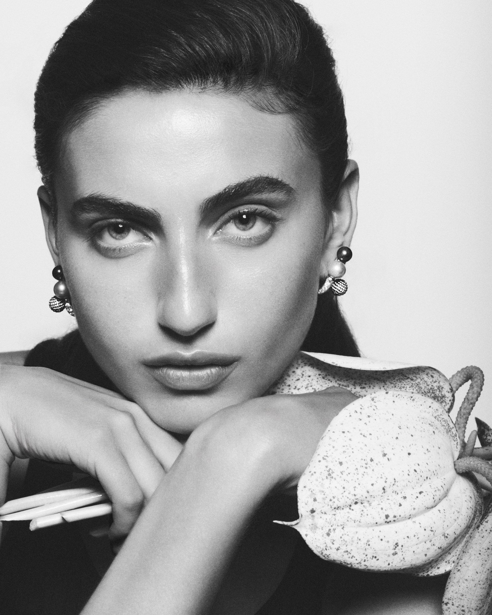 Front-facing black-and-white campaign portrait showing Repossi Sphere Earrings