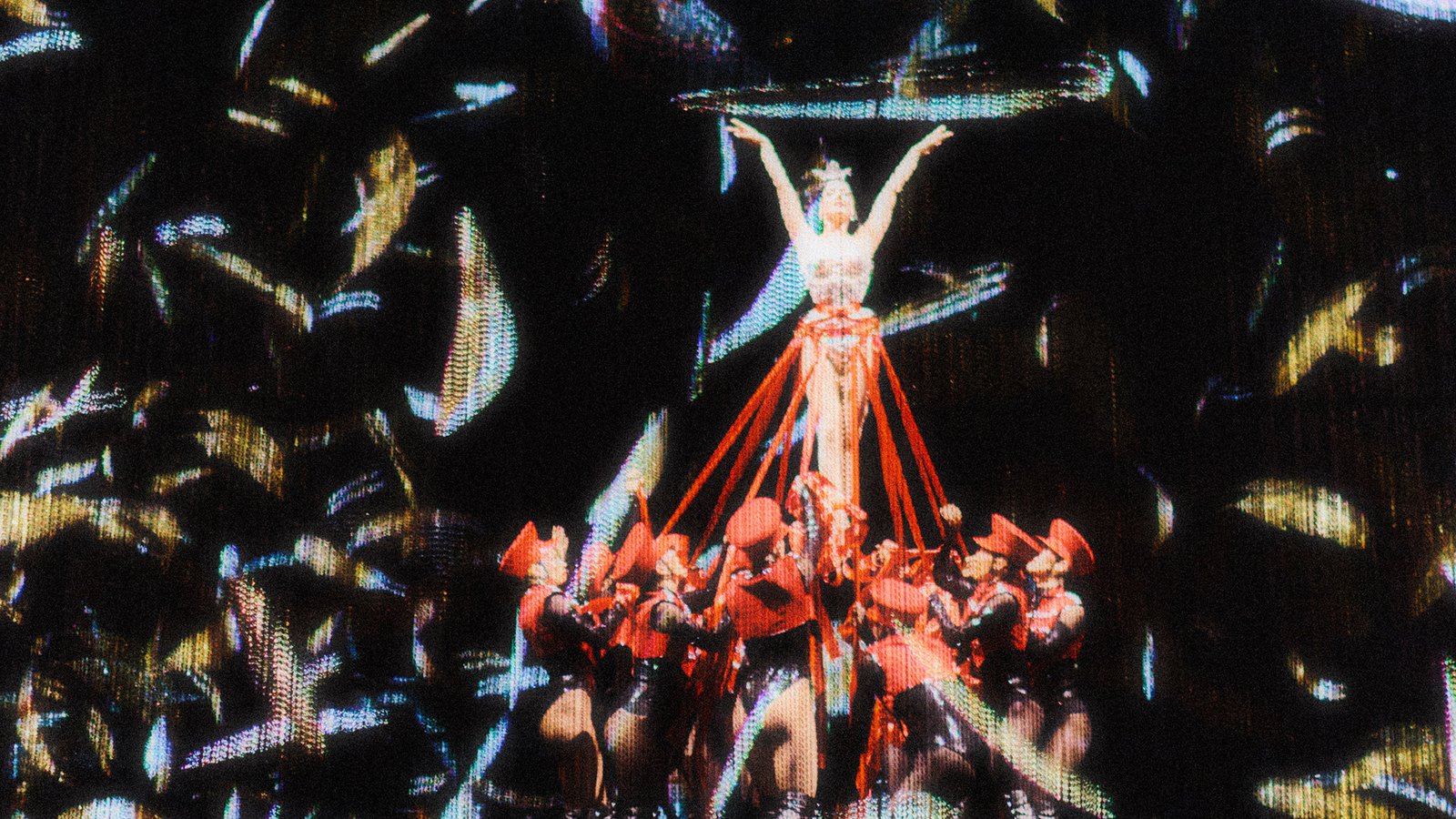 Dita Von Teese elevated above dancers in the Eternal Youth stage production