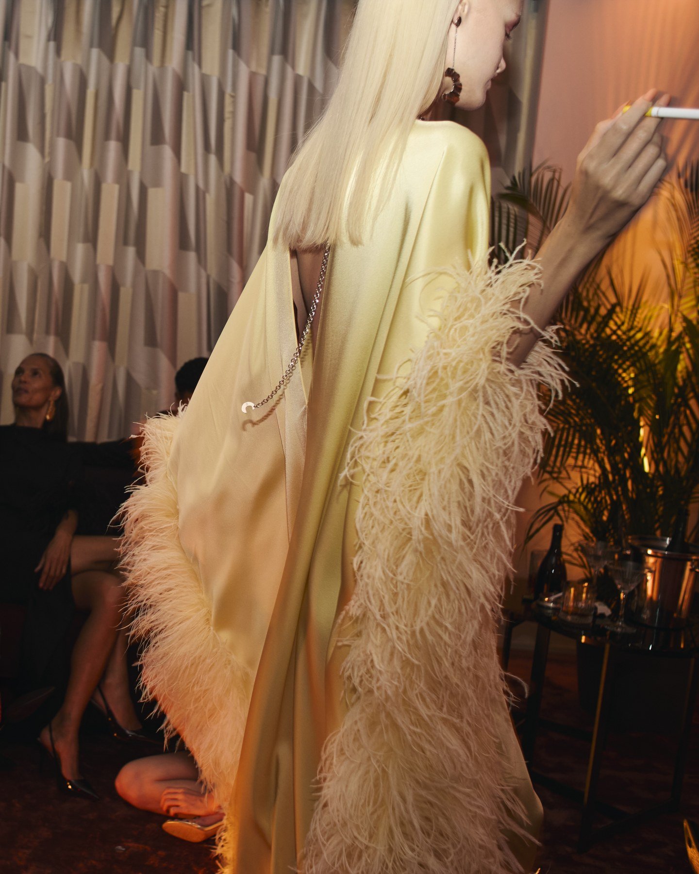 Pale yellow Taller Marmo gown with long feather-trimmed sleeves