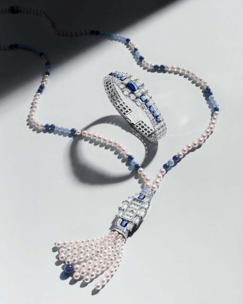 Sapphire-set Grand Lady Kalla bracelet arranged inside its pearl sautoir with a pendant watch and tassel