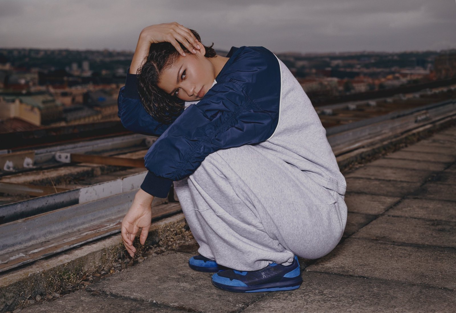 Zendaya in a blue top and loose pale trousers in the On campaign